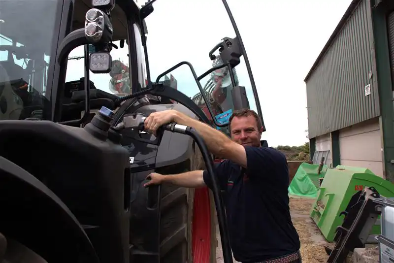 Olly Harrison Stood Refuelling Tractor with Certas Energy fuel.